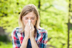 CEENTA Woman with allergy symptom blowing nose